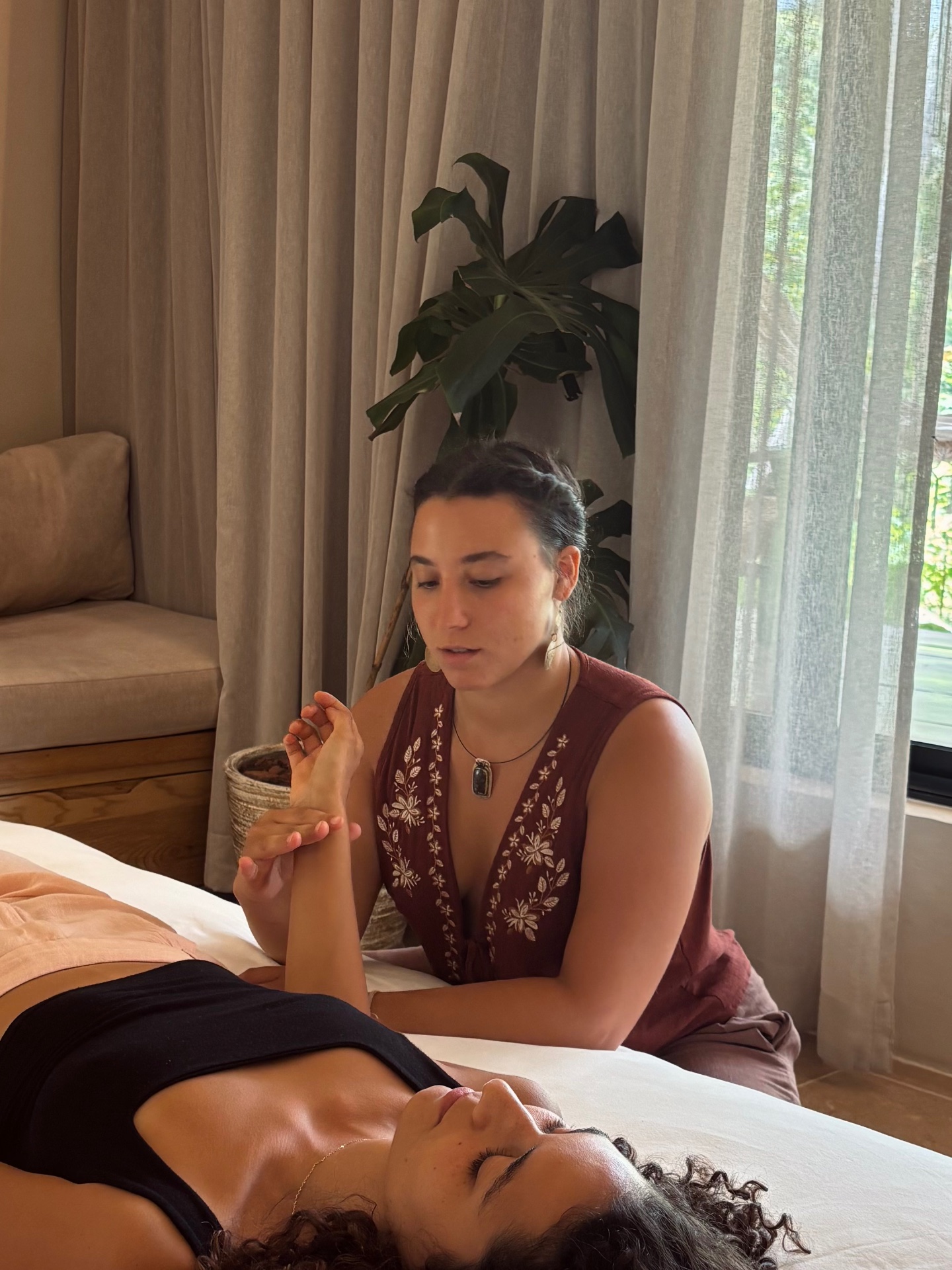 Practitioner gently holding a client's hand during a craniosacral session